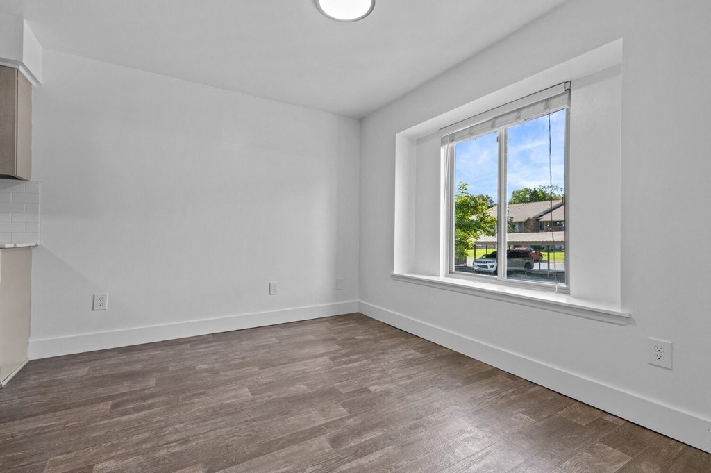 an empty living room with a large window and wood flooring at Edge At Farmington Hills - Farmington Hills, MI, Michigan, 48334