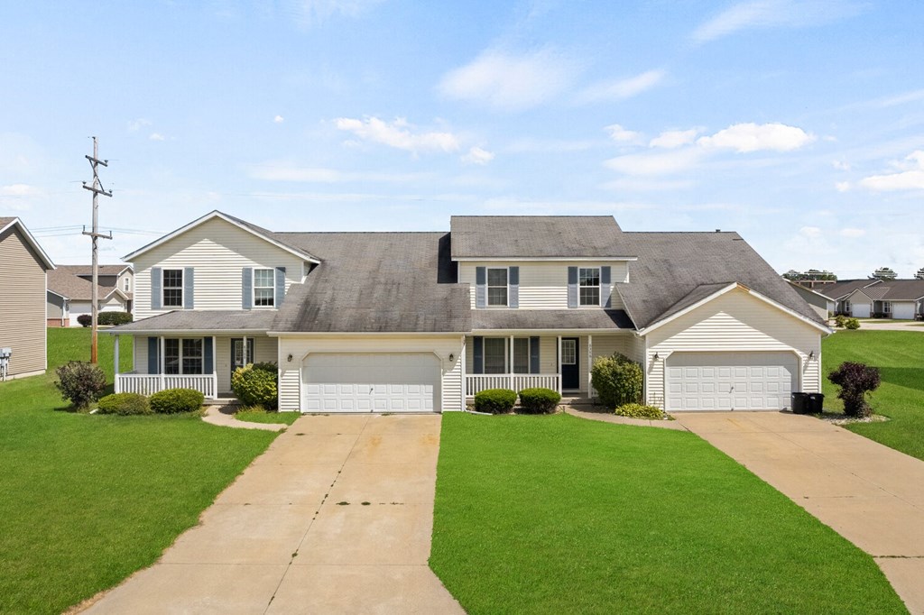 a white house with a lawn in front of it