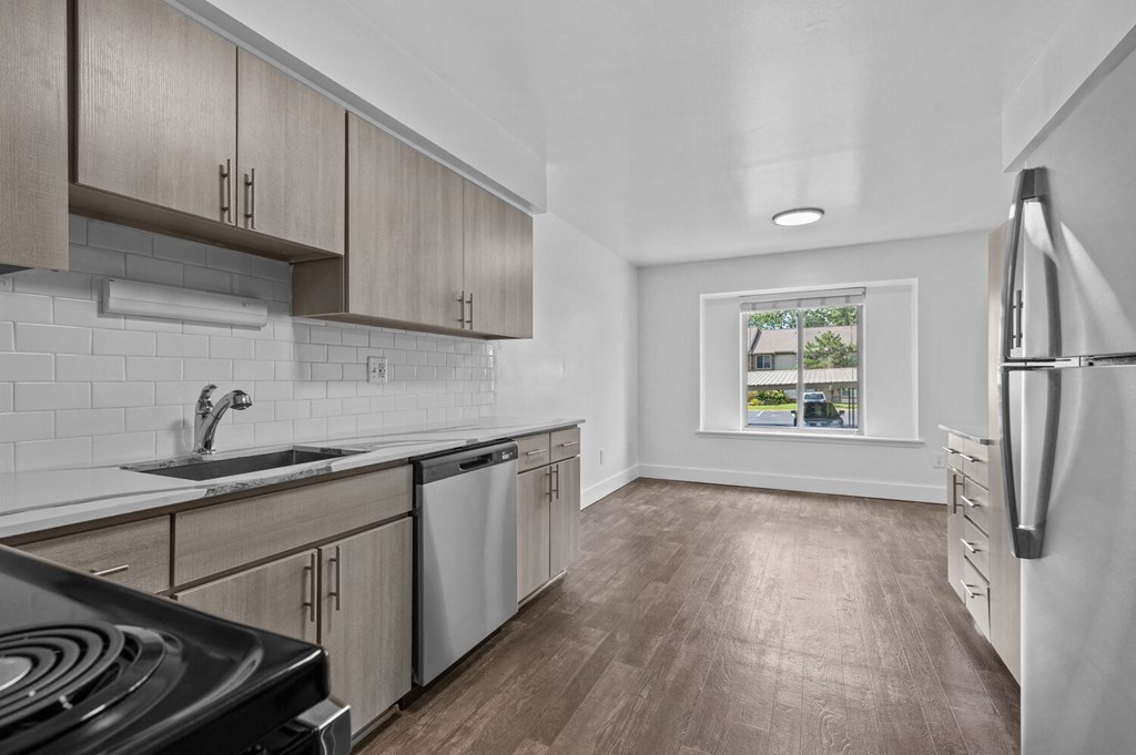 an empty kitchen with wood flooring and stainless steel appliances at Edge At Farmington Hills - Farmington Hills, MI, Michigan