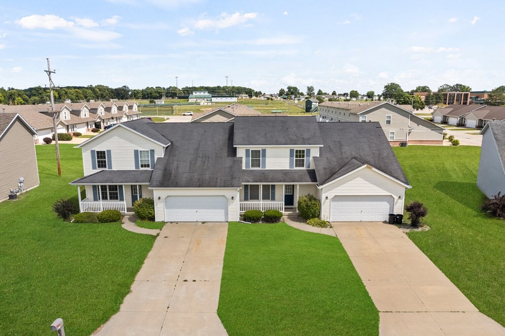 a house with a gray roof on a green lawn
