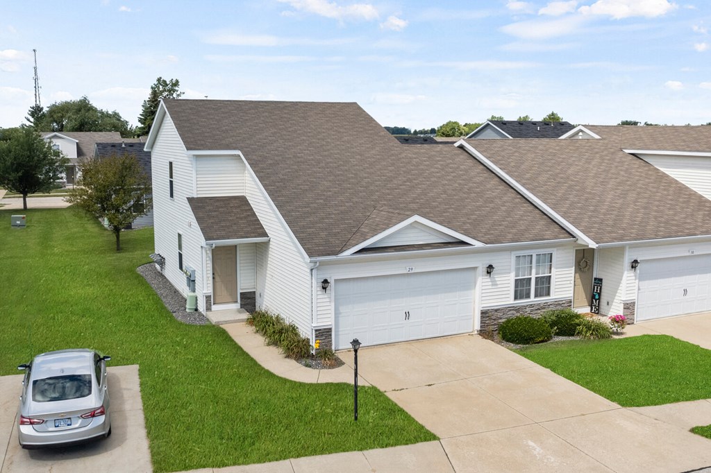 a white house with a car parked in front of it
