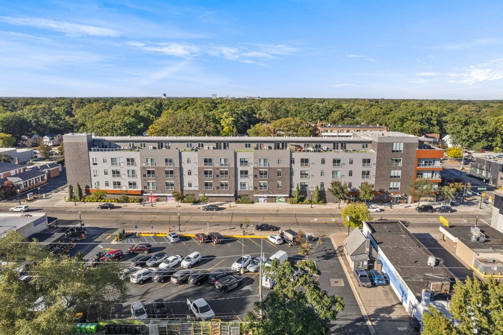 a large apartment building with a parking lot in front of it
