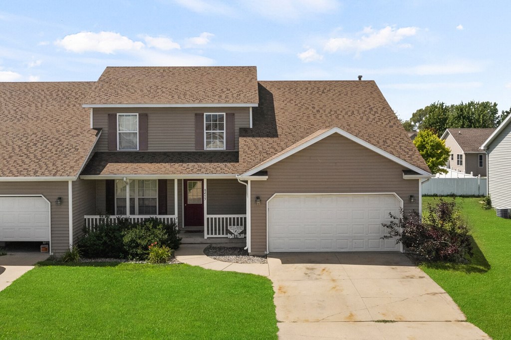 a house with a brown roof and a white garage door