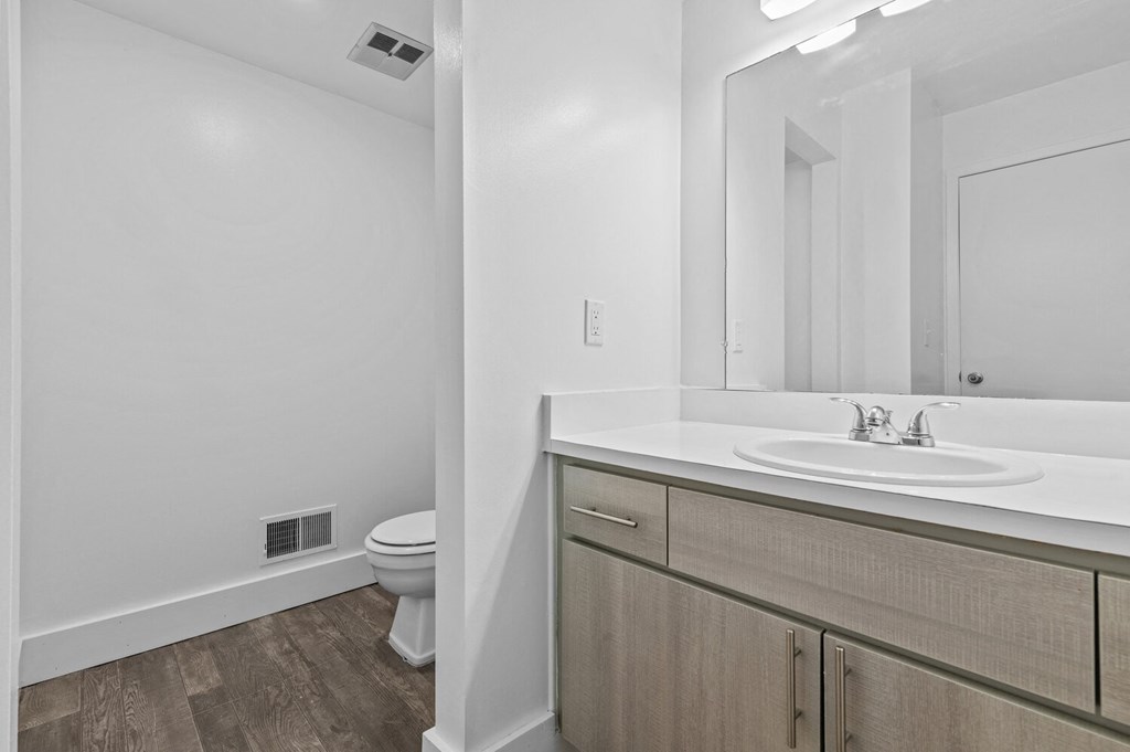a bathroom with a sink and a toilet and a mirror at Edge At Farmington Hills - Farmington Hills, MI, Michigan, 48334