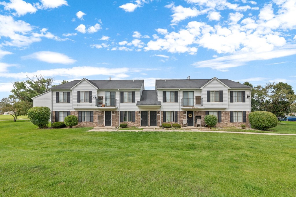 a large house with a green lawn in front of it