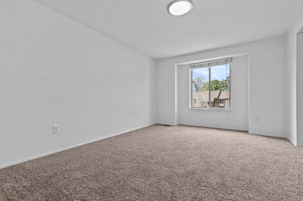 an empty room with carpet and a window at Edge At Farmington Hills - Farmington Hills, MI, Michigan