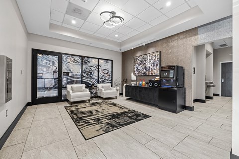 A modern living room with a black entertainment center and a large abstract painting on the wall.