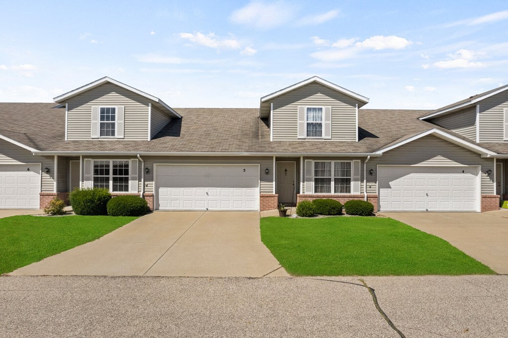 a house with two garage doors and a lawn