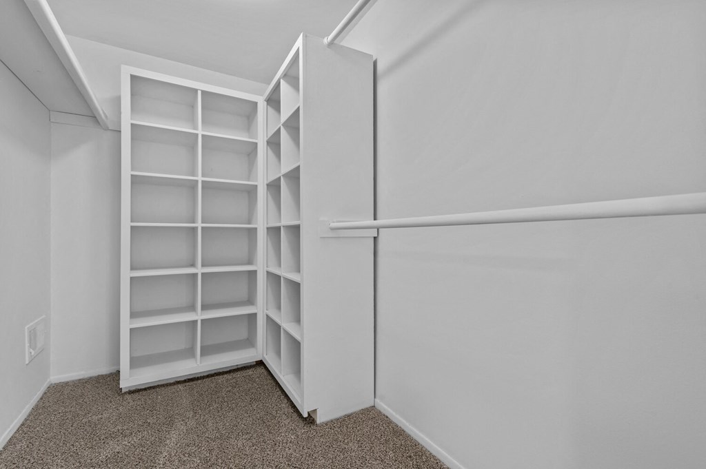the closet in a small apartment with white shelves and a white wall at Edge At Farmington Hills - Farmington Hills, MI, Michigan, 48334