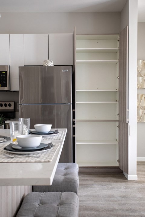 a kitchen with a counter top and a refrigerator