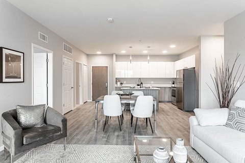 a living room and kitchen with a table and chairs