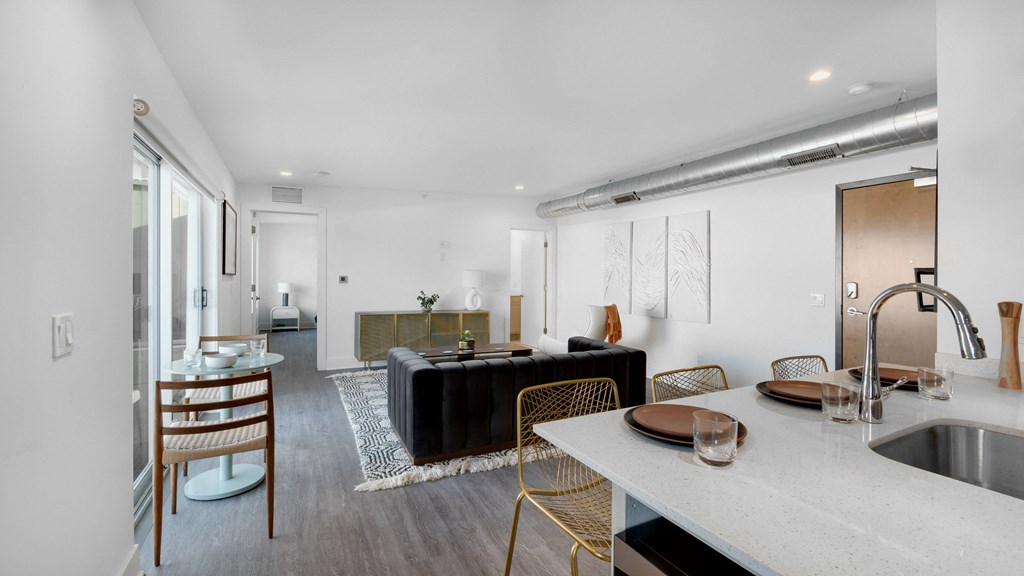 a living room with a kitchen and a dining table
