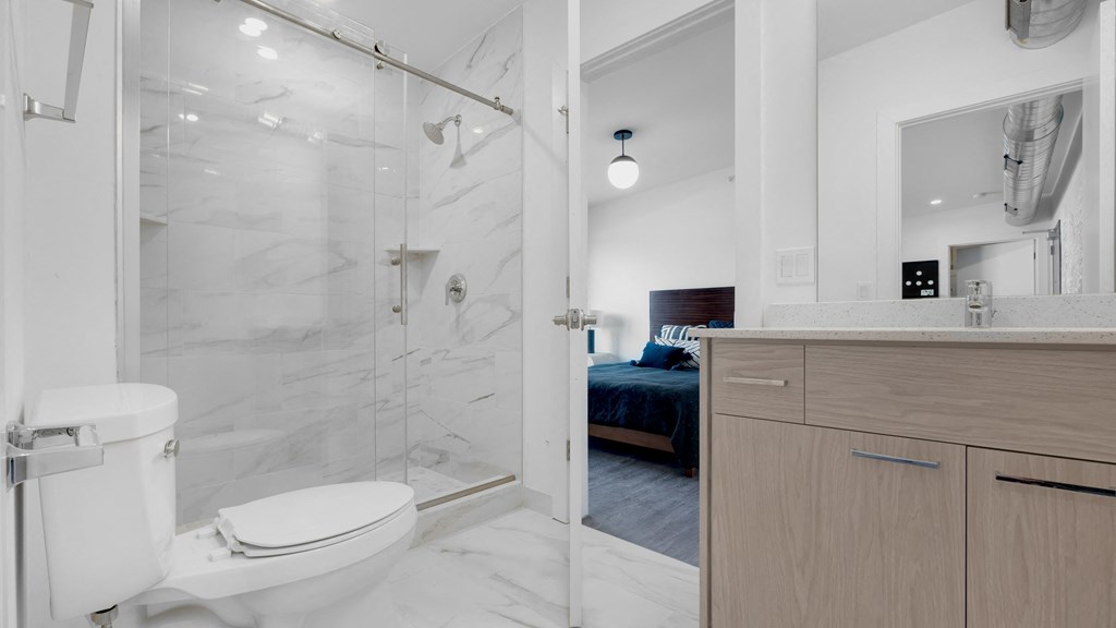 a bathroom with a shower and a bed