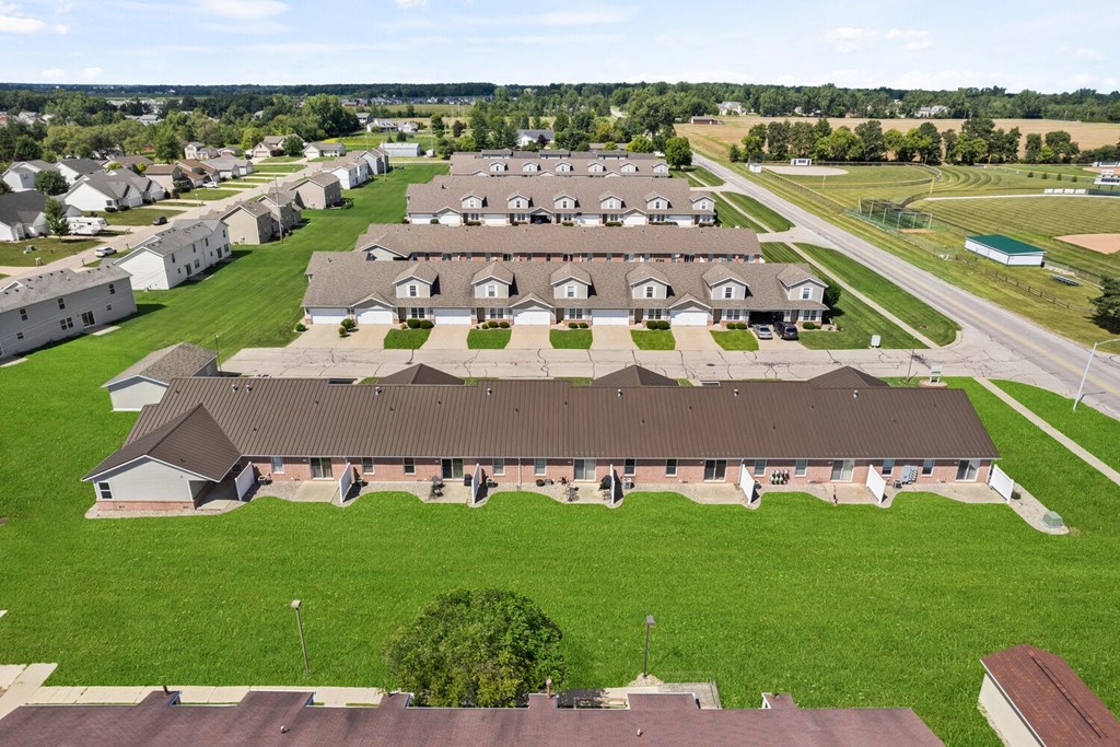 an aerial view of a group of buildings in a field