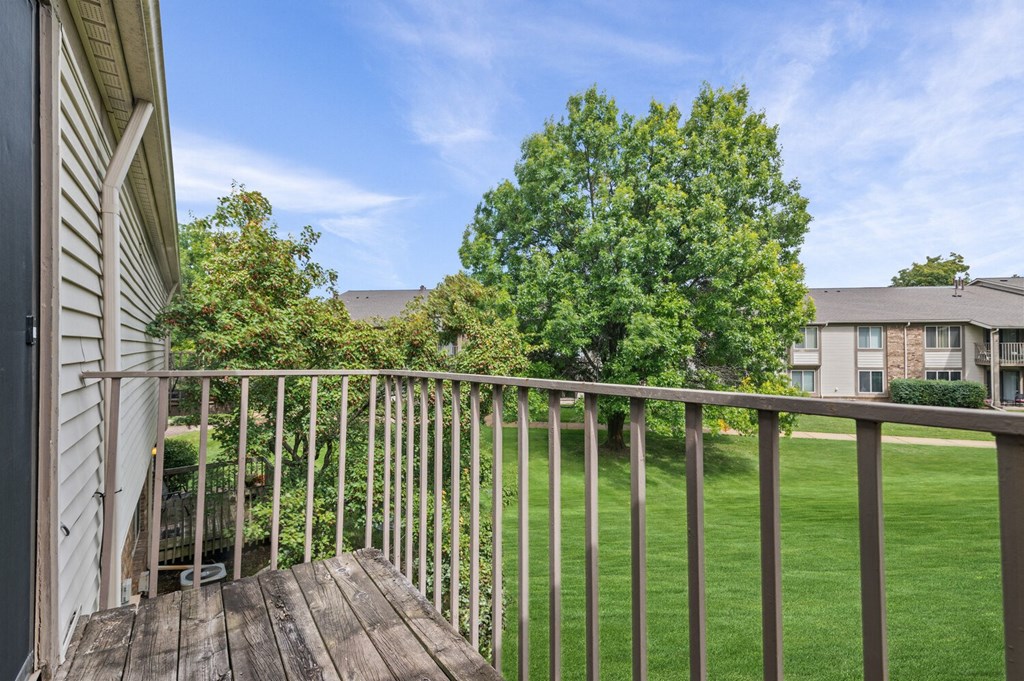 the view from the deck of a home with a yard and a tree at Edge At Farmington Hills - Farmington Hills, MI, Michigan, 48334