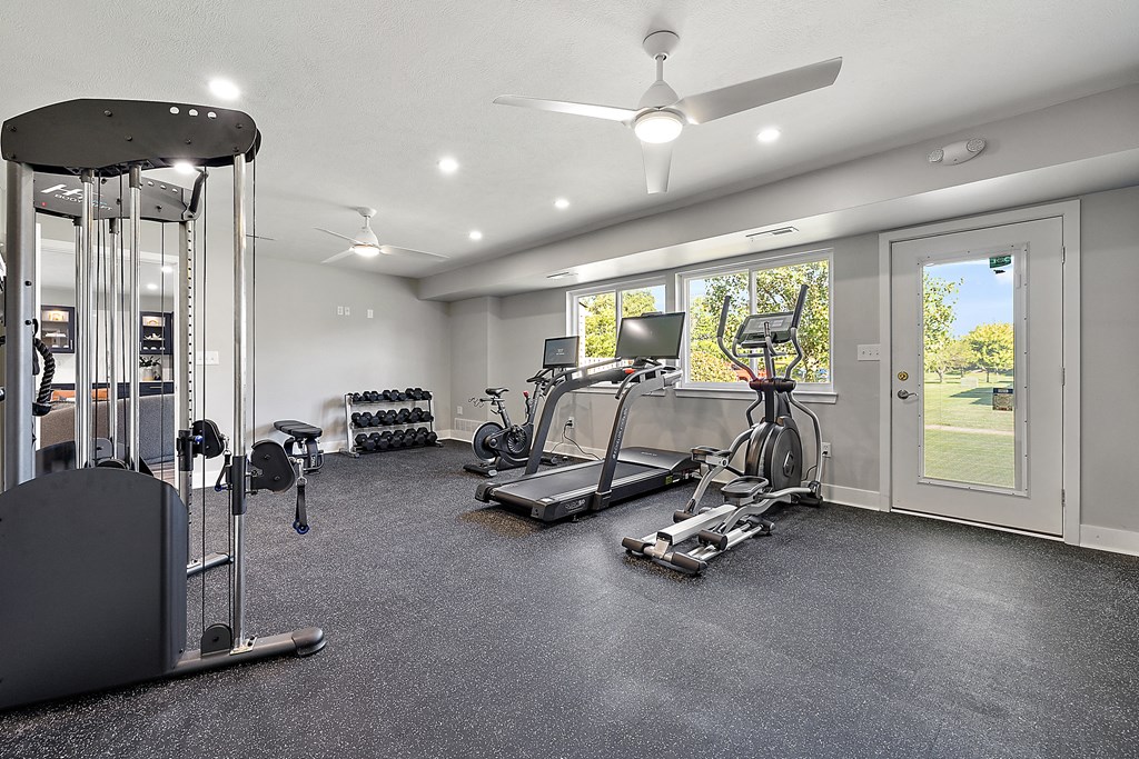 a home gym with exercise equipment and a window at Sunnymede Apartments - Troy, MI, Troy, Michigan