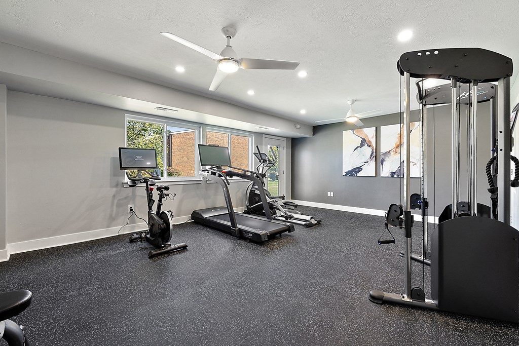 a home gym with exercise equipment and a tv at Sunnymede Apartments - Troy, MI, Troy, 48084