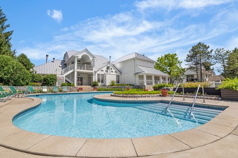 A large house with a pool in the backyard.