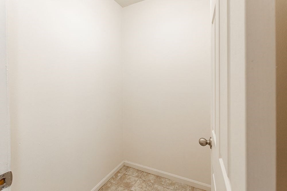 an empty room with a white wall and a door