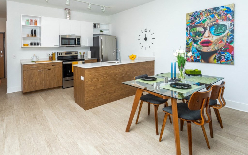 a kitchen and dining room with a table and chairs