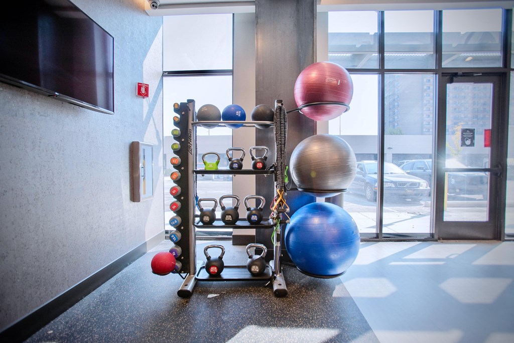 a collection of balls and spheres on a rack in a room
