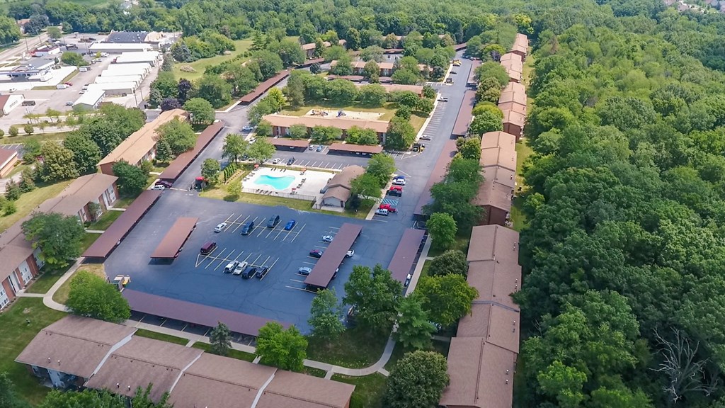 an aerial view of a parking lot and other buildings