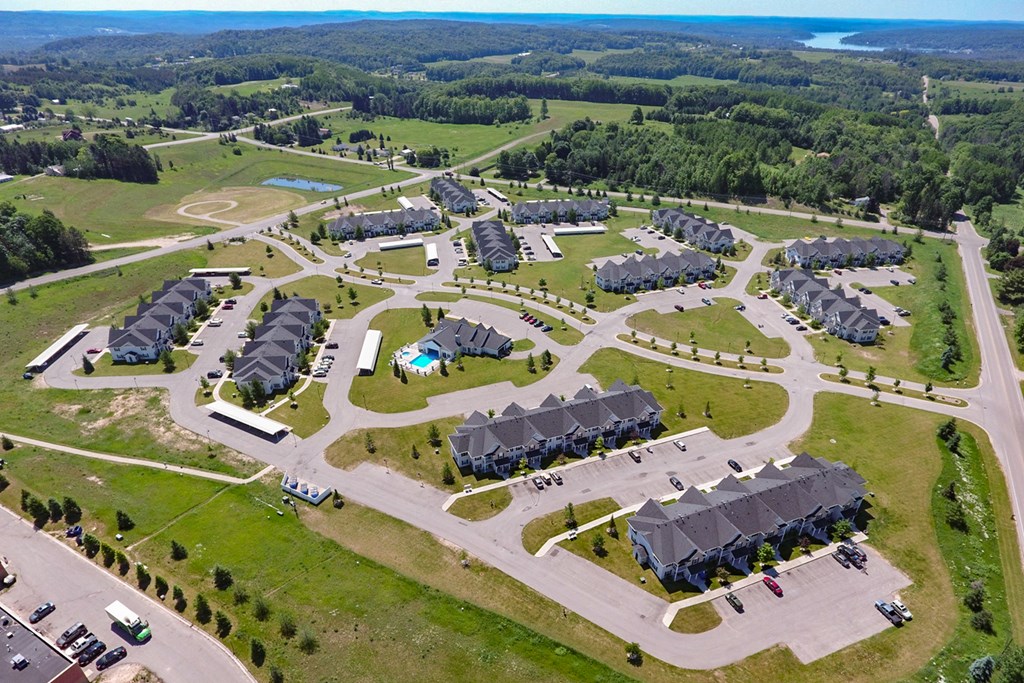 an aerial view of a community of houses and parking lots
