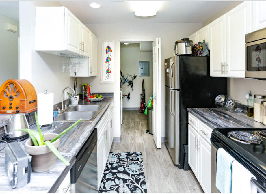 a small kitchen with black appliances and white cabinets