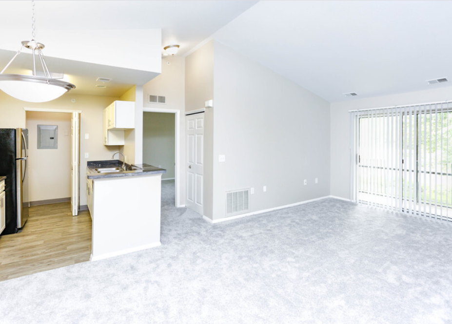 an empty living room and kitchen in a new home
