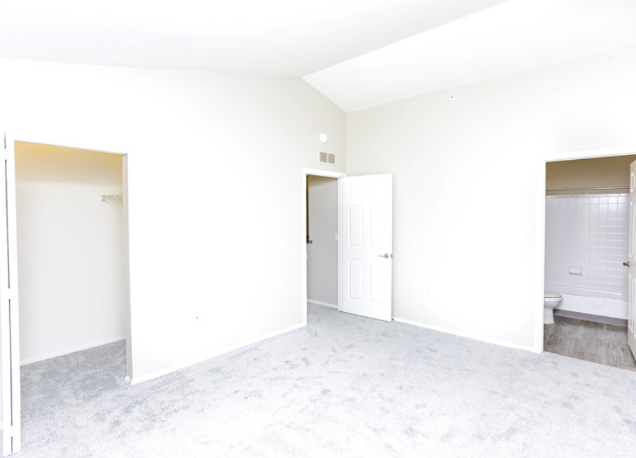 an empty living room with white walls and white doorways