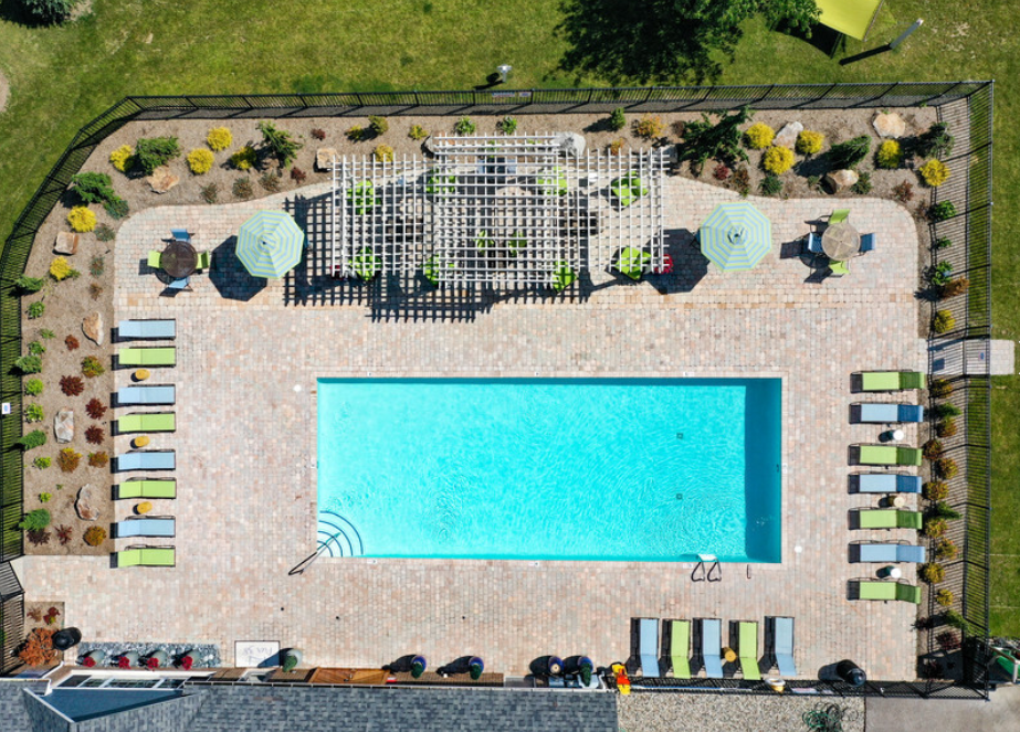 a birds eye view of a swimming pool in a garden