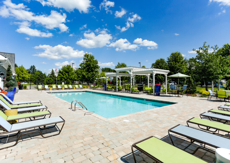 our resort style swimming pool is surrounded by lounge chairs