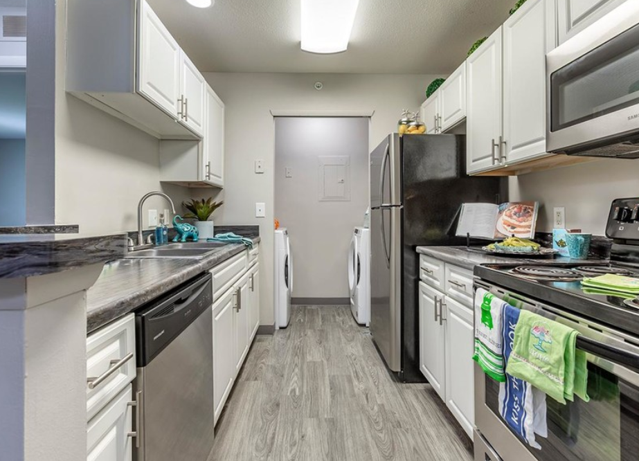 a kitchen with stainless steel appliances and white cabinets