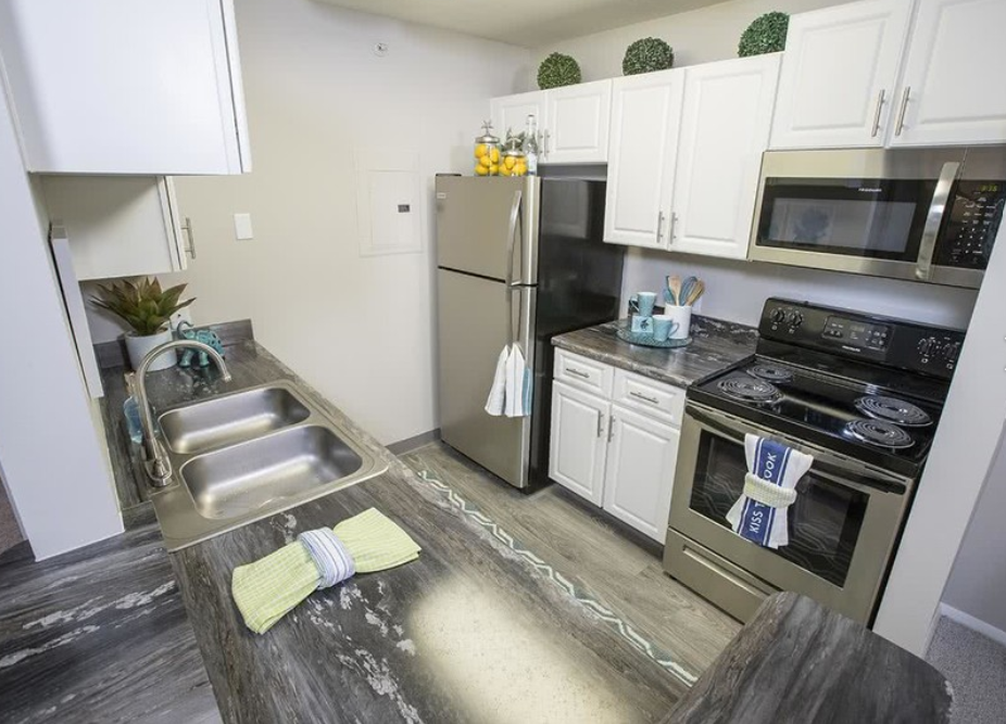 a kitchen with stainless steel appliances and white cabinets