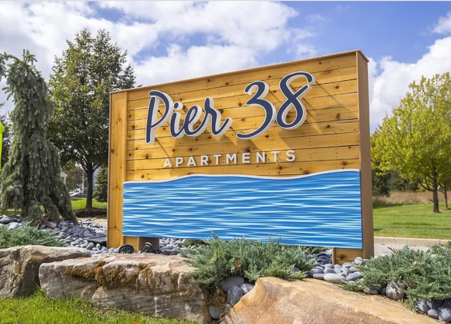 a sign for pnr 33 apartments in front of a water sign