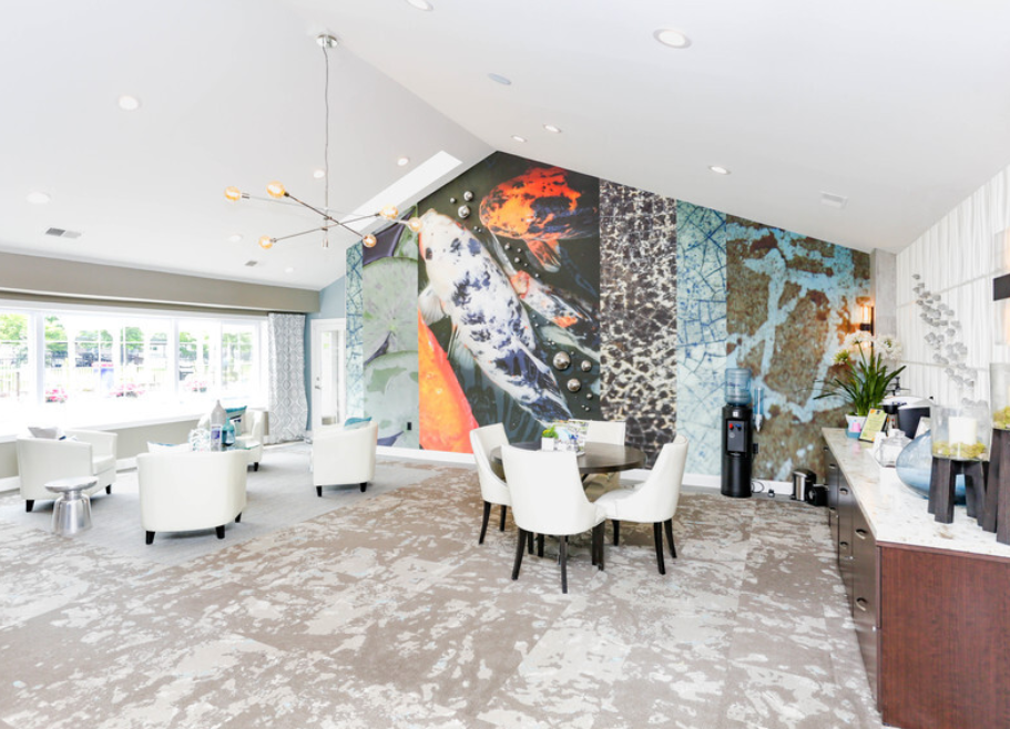 a living room with a large wall mural and a table and chairs