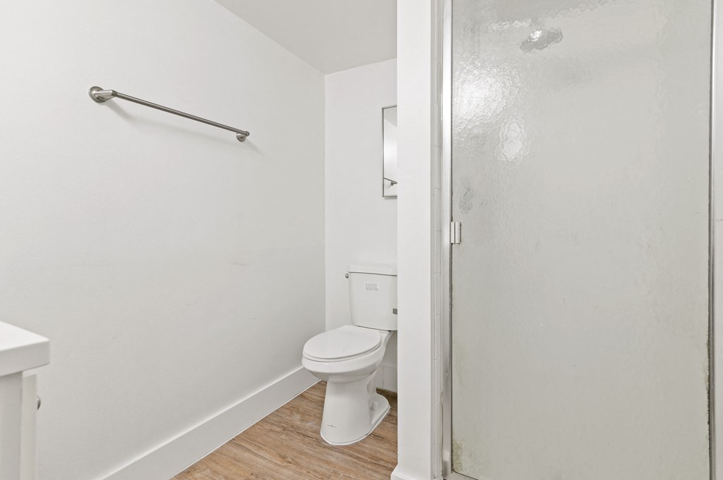 an empty bathroom with a toilet and a shower