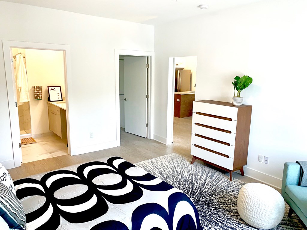 a bedroom with a bed and a dresser and a closet