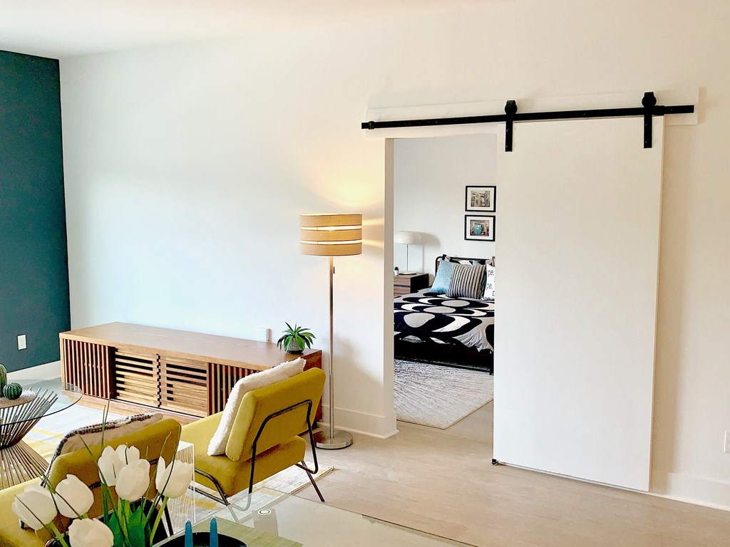 a living room with a sliding door to a bedroom