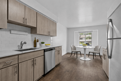 A kitchen with wooden cabinets and a white fridge.