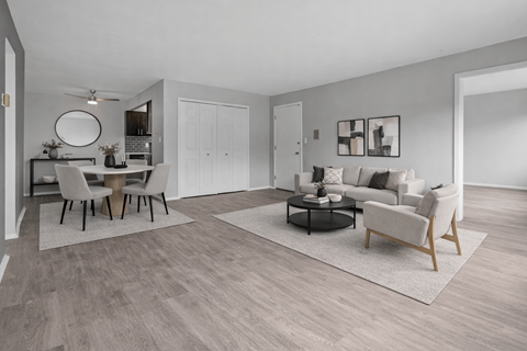 A modern living room with a dining table and chairs.
