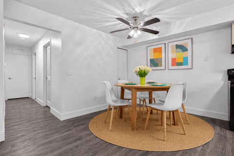Dining area with modern furniture and ceiling fan at Pilgrim Village - Canton, MI Apartments, Michigan
