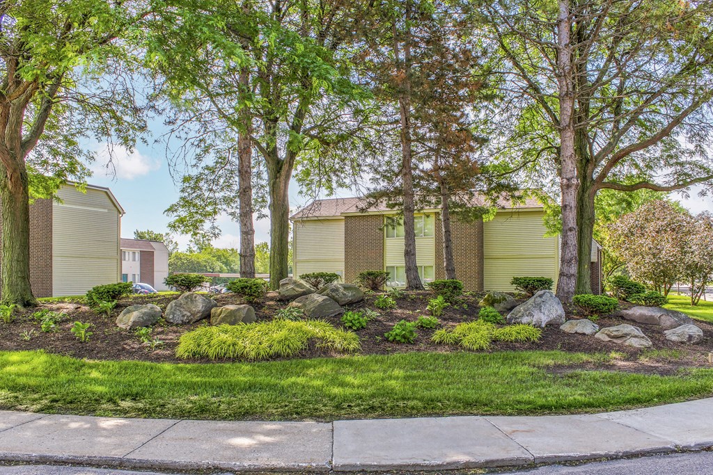 a home with a landscaped yard with rocks and trees