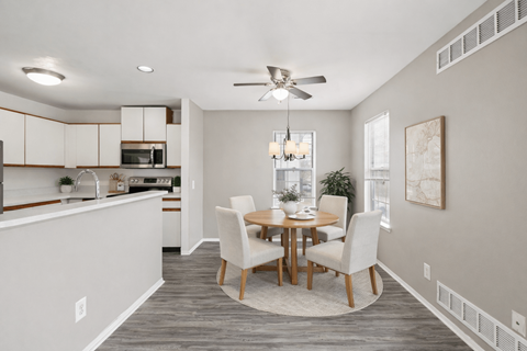 A dining room with a table set for four.