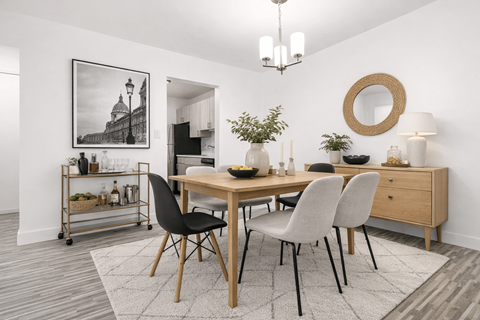 A dining room with a wooden table and chairs.