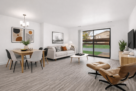 A modern living room with a dining table and chairs.