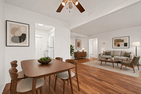 A modern dining room with a wooden table and chairs.