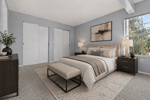 A bedroom with a large bed and a bench in front of it.