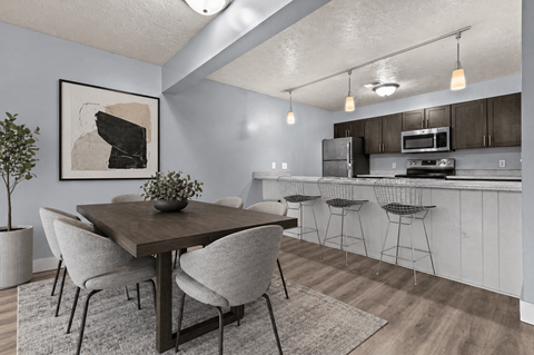 A dining area with a table and chairs.