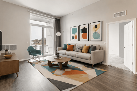 A living room with a sofa, a chair, a coffee table, and a rug.